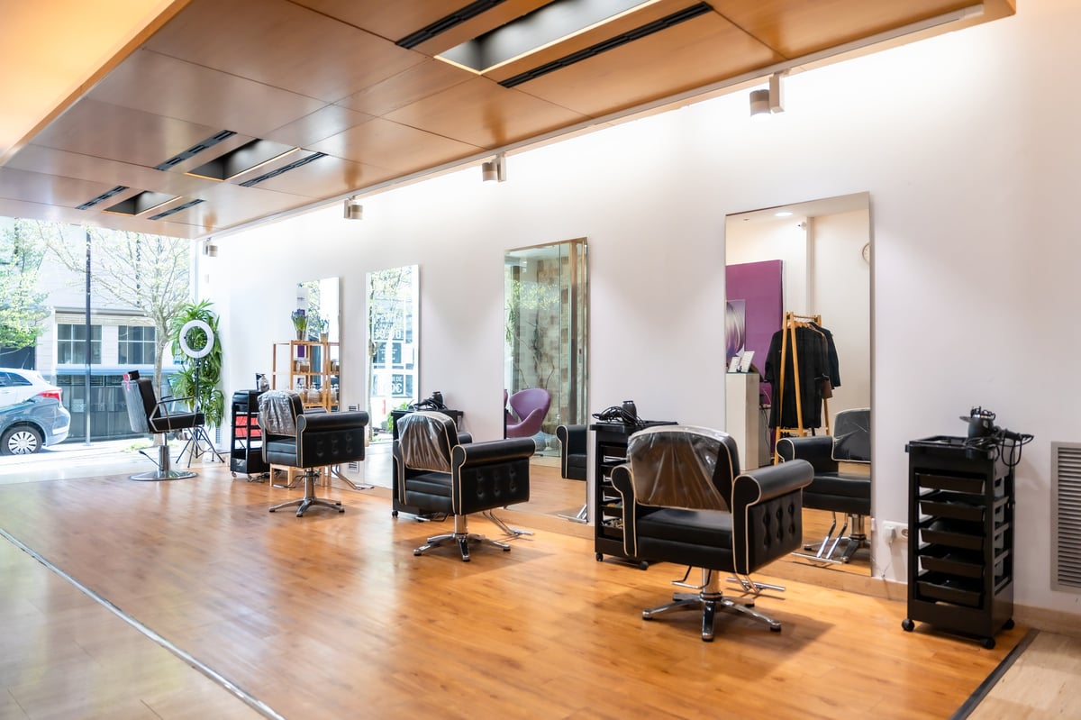 The Hair by Trish studio in Haverford — styling chairs, mirrors and warm wood floors